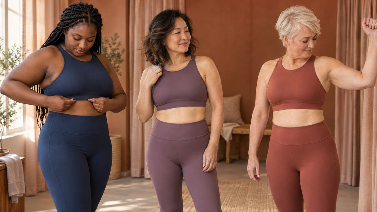 Three women check supportive sports-bra fit in a private studio