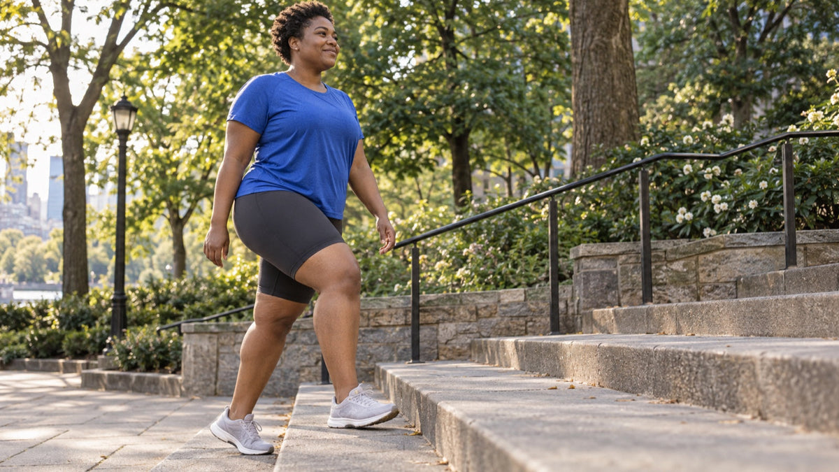 Plus-size woman walks comfortably up park steps in biker shorts