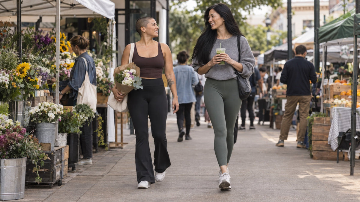 Two women compare flare and regular leggings on a neighborhood walk