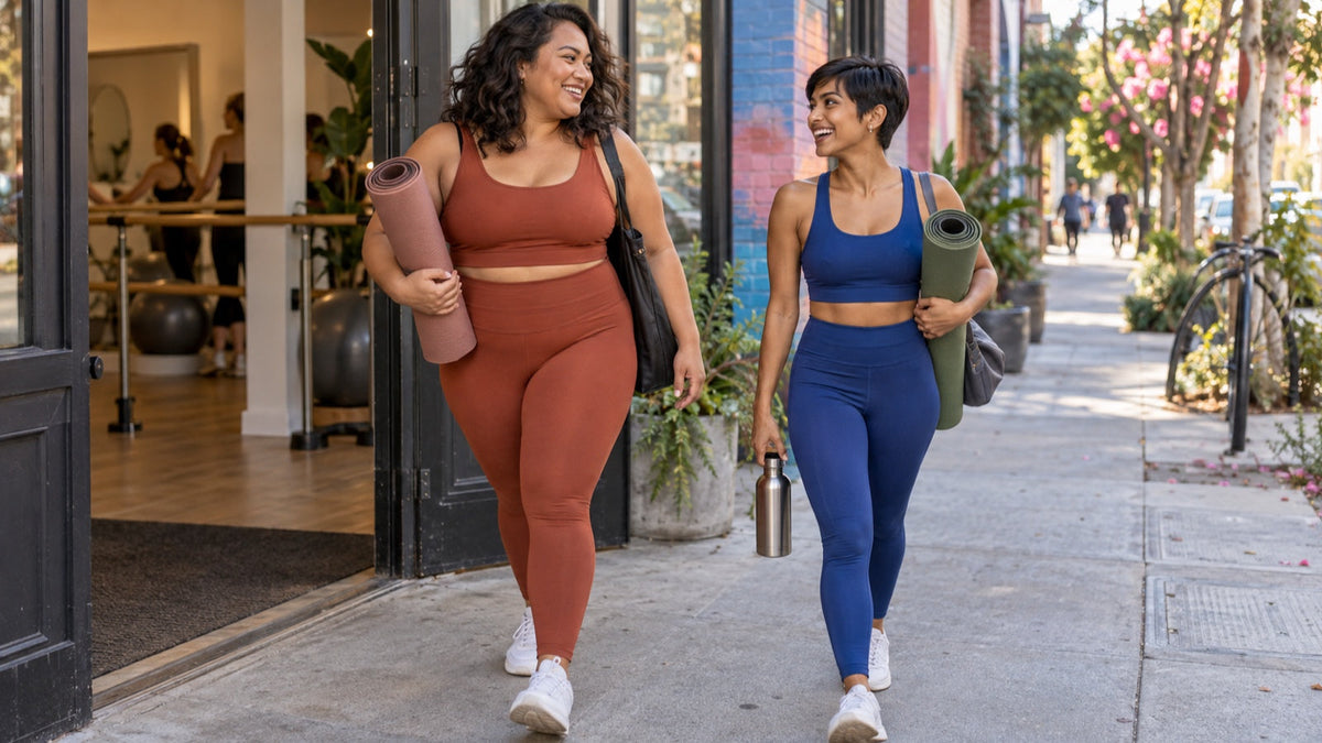 Two friends leave a barre studio in distinct matching activewear sets