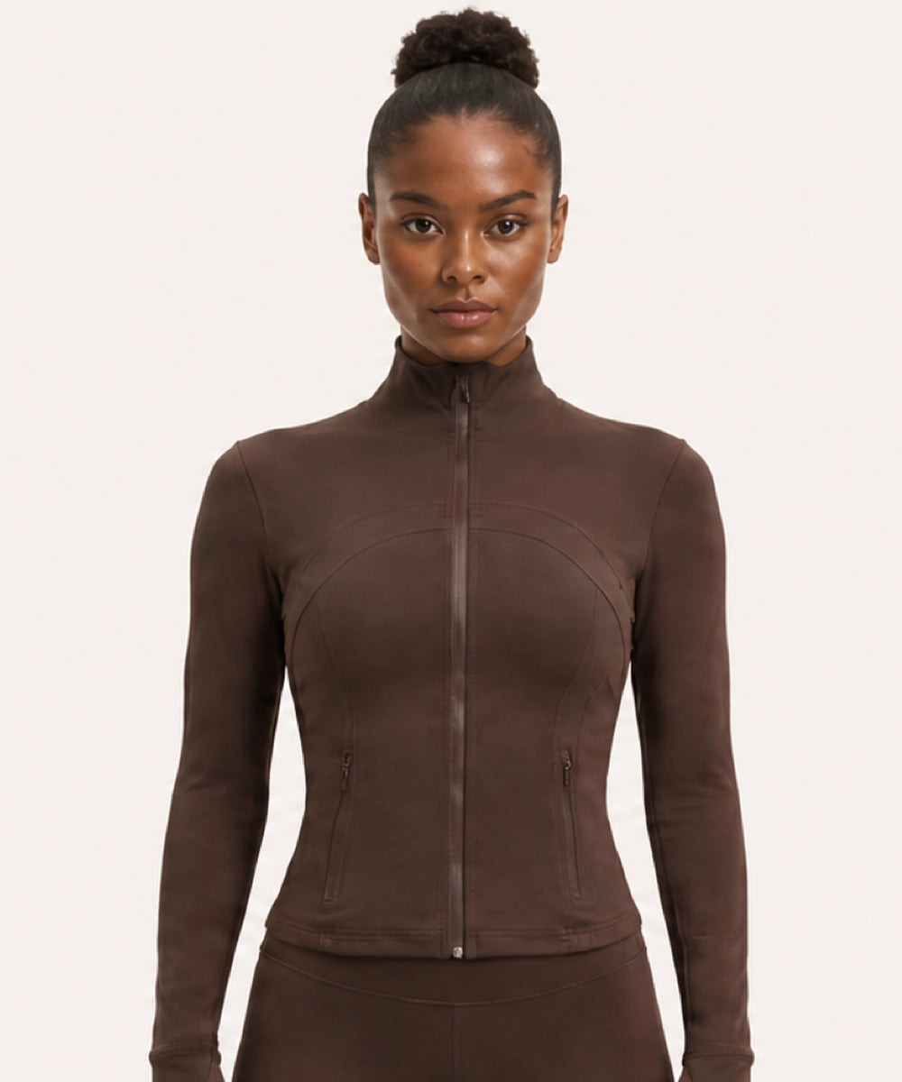 Woman wearing a brown fitted zip-up activewear jacket with coordinating bottoms